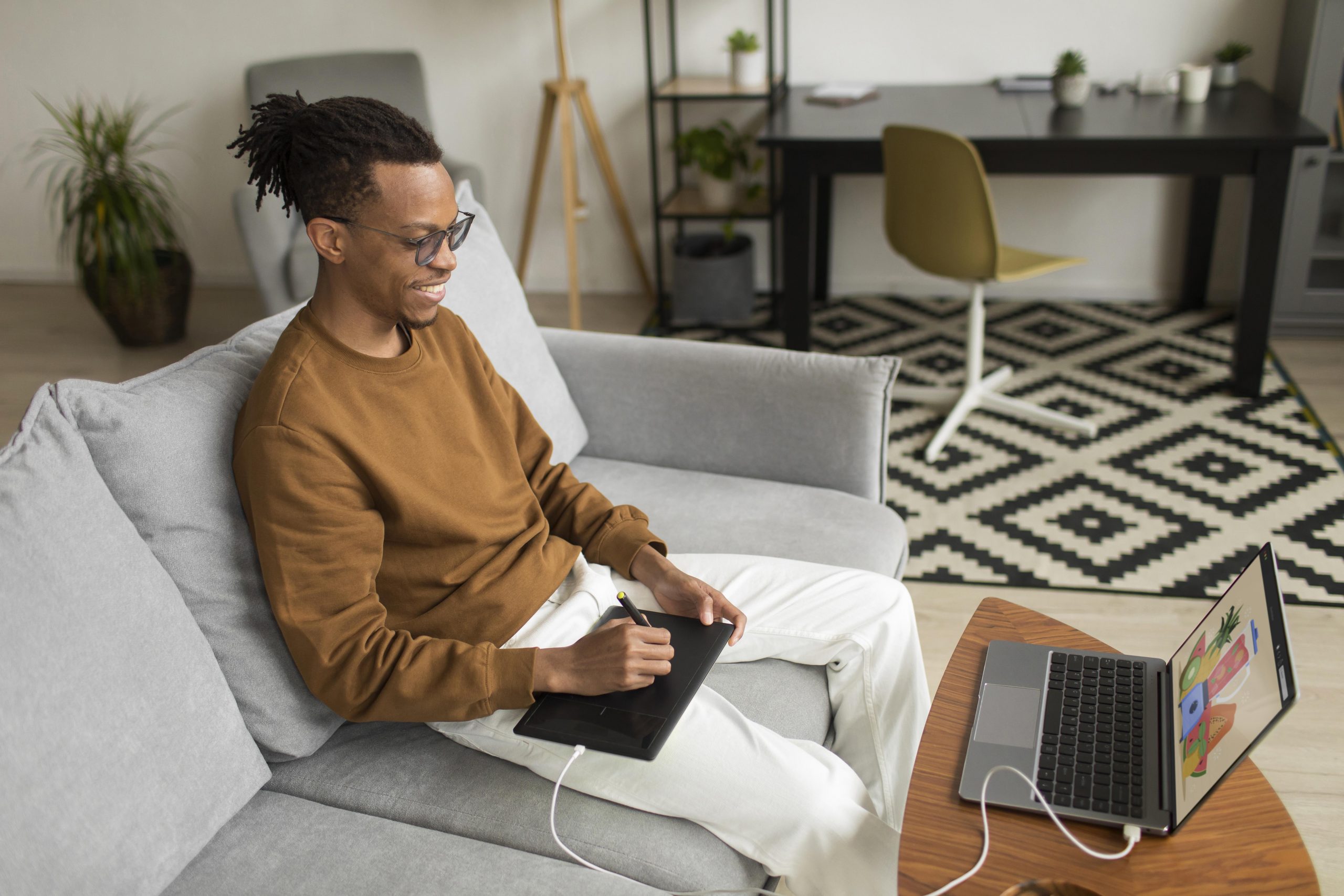 man drawing with graphic tablet in the comfort of his own home